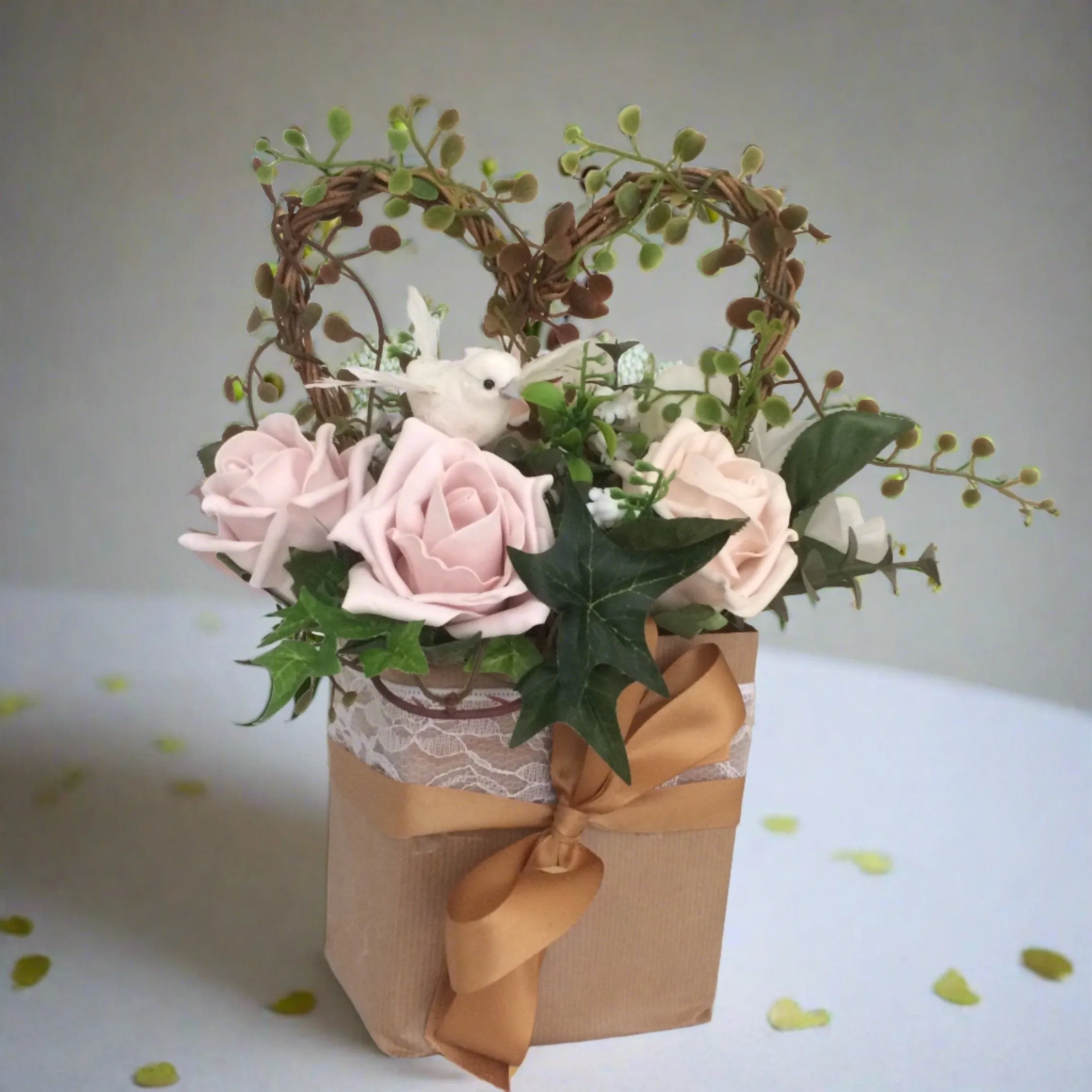 flower arrangement of artificial mocha foam roses in a gift bag