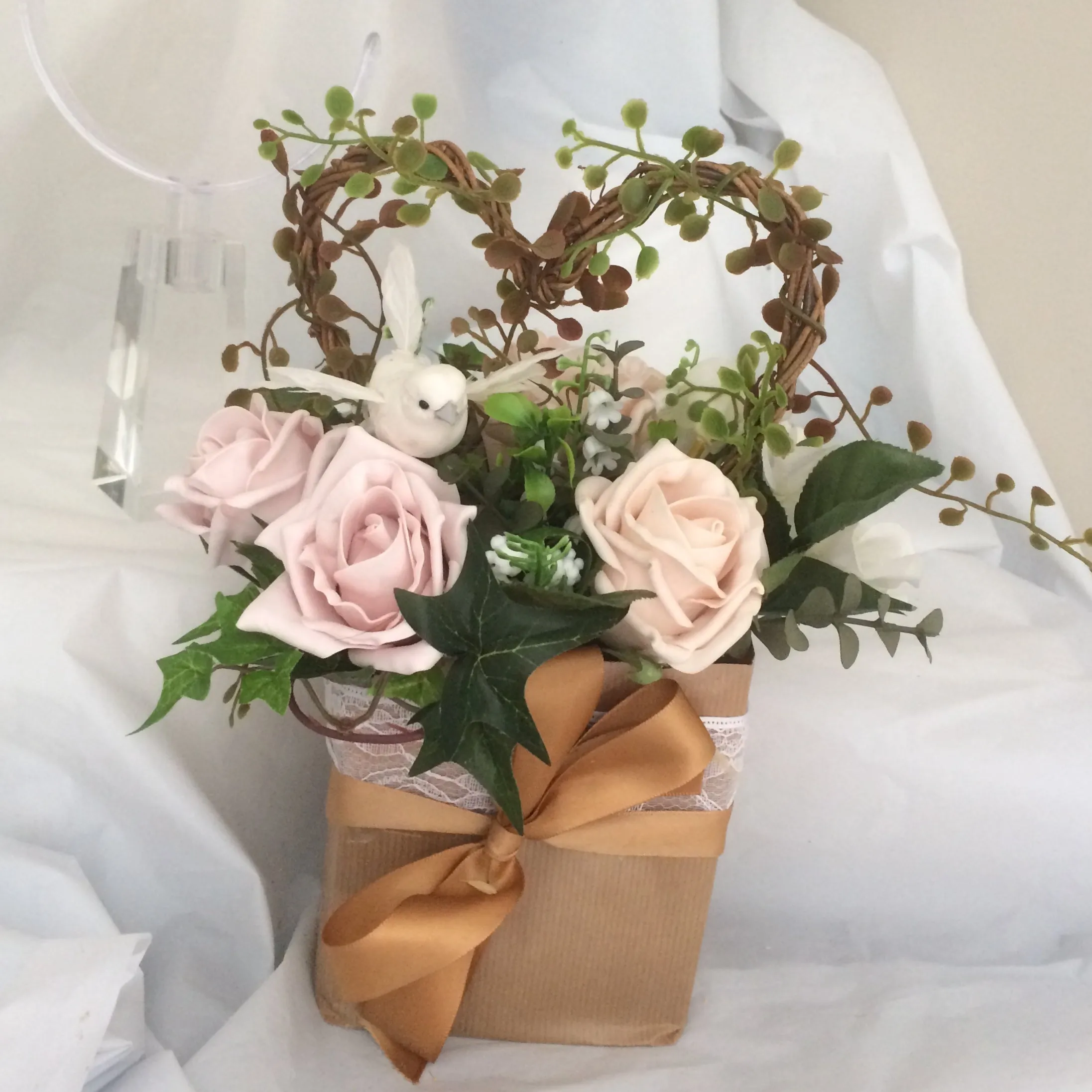 flower arrangement of artificial mocha foam roses in a gift bag